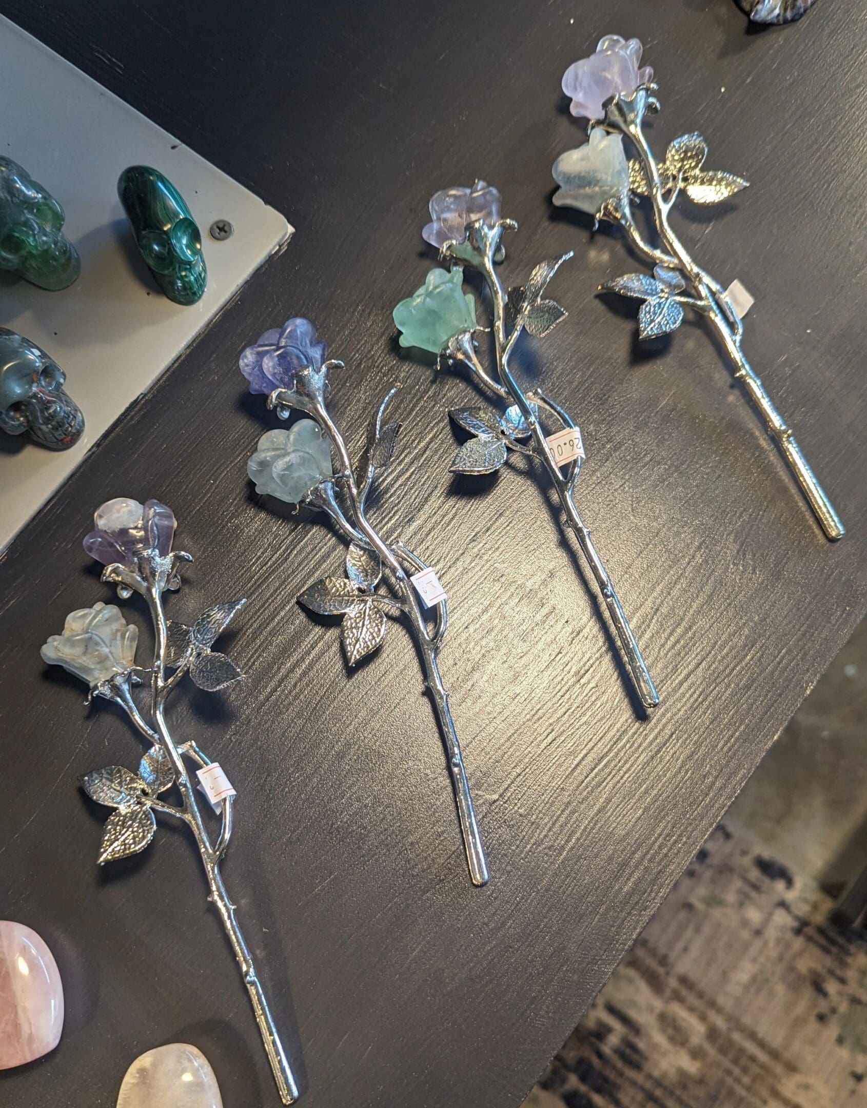 A table with four metal flowers on it