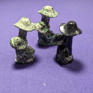 A group of four green and black figurines.