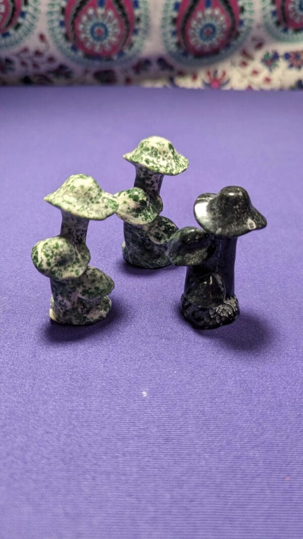 A group of four green and black figurines.