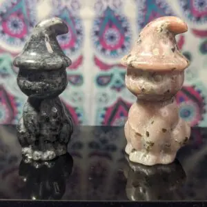 Two ceramic figurines are sitting on a table.