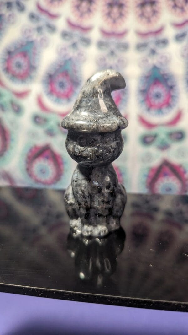 A small statue of an elephant wearing a hat.