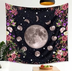 A tapestry with flowers and the moon in the center.