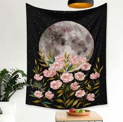 A painting of flowers and the moon on a wall.