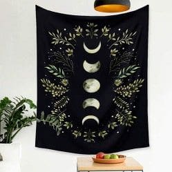 A black and white tapestry with leaves and moon phases.