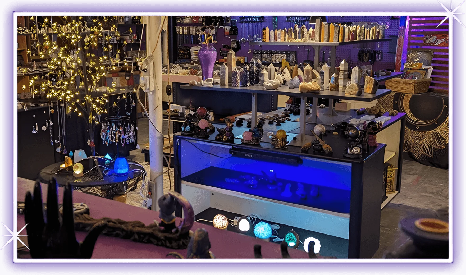 A purple room with many glass items on the counter.