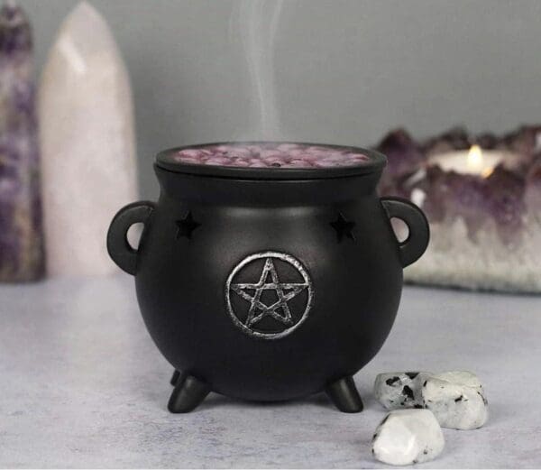 A black cauldron with smoke coming out of it.