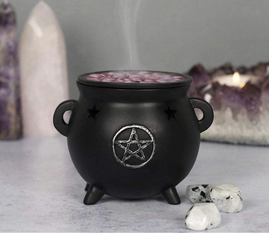 A black cauldron with smoke coming out of it.