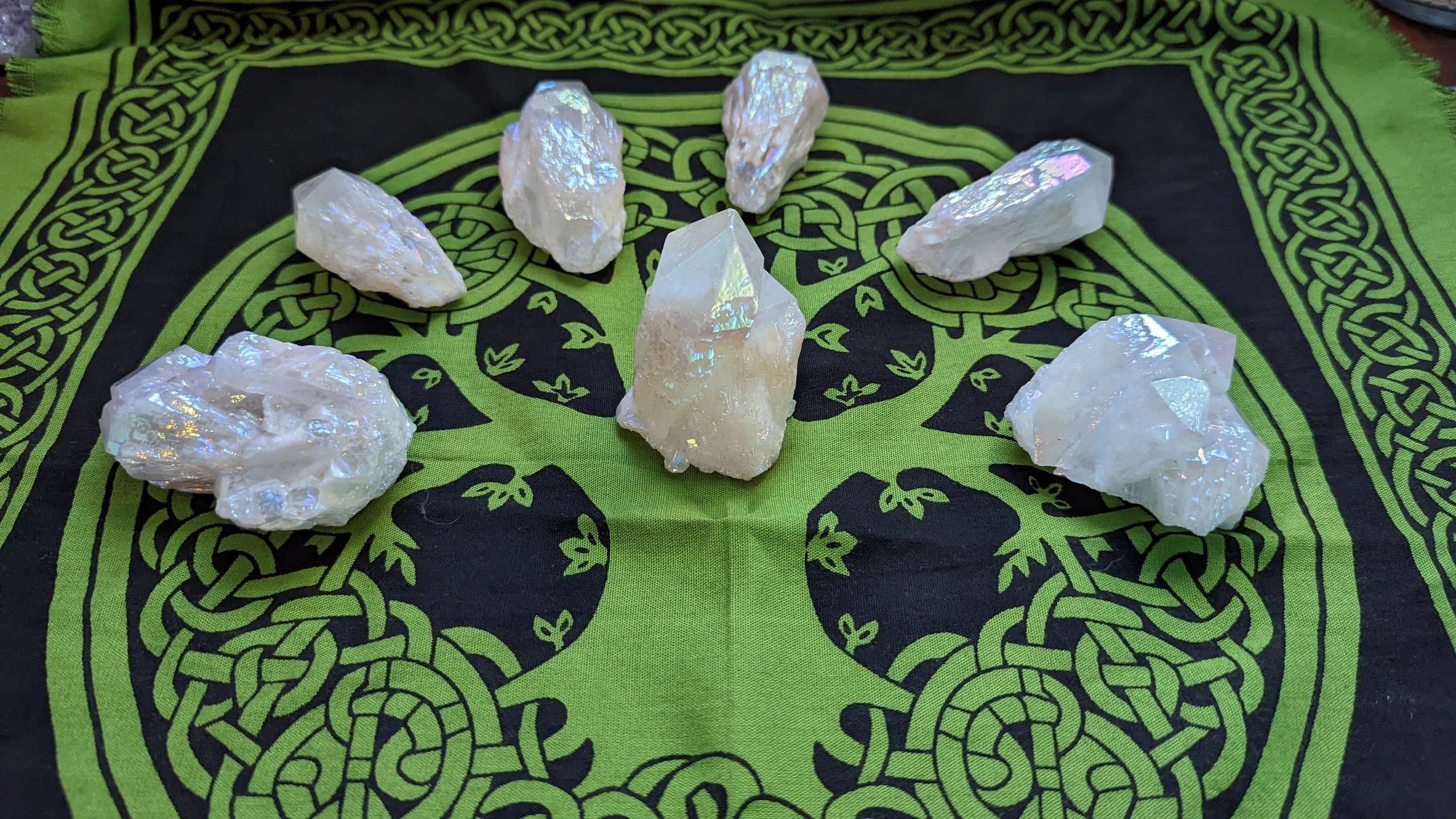 A green and black table with white rocks on it