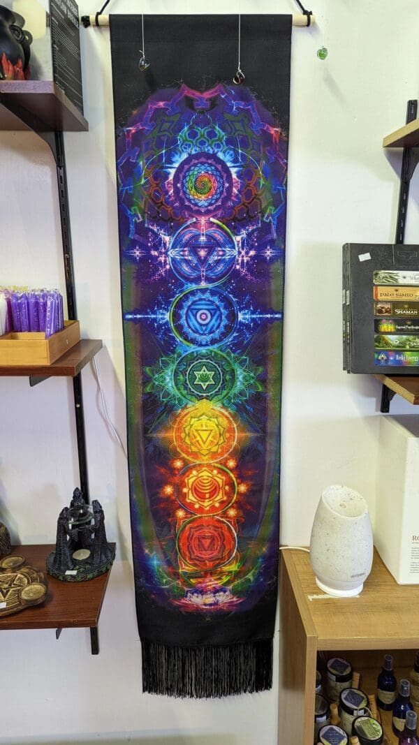 A large tapestry with seven different colored chakras.