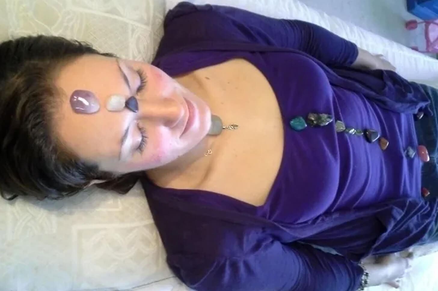 A woman laying on her stomach wearing purple.