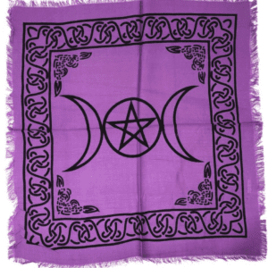 A purple altar cloth with black triangles and pentagram.