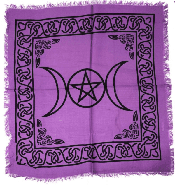 A purple altar cloth with black triangles and pentagram.