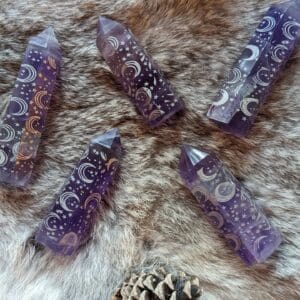 Five purple and white crystals on a fur surface.