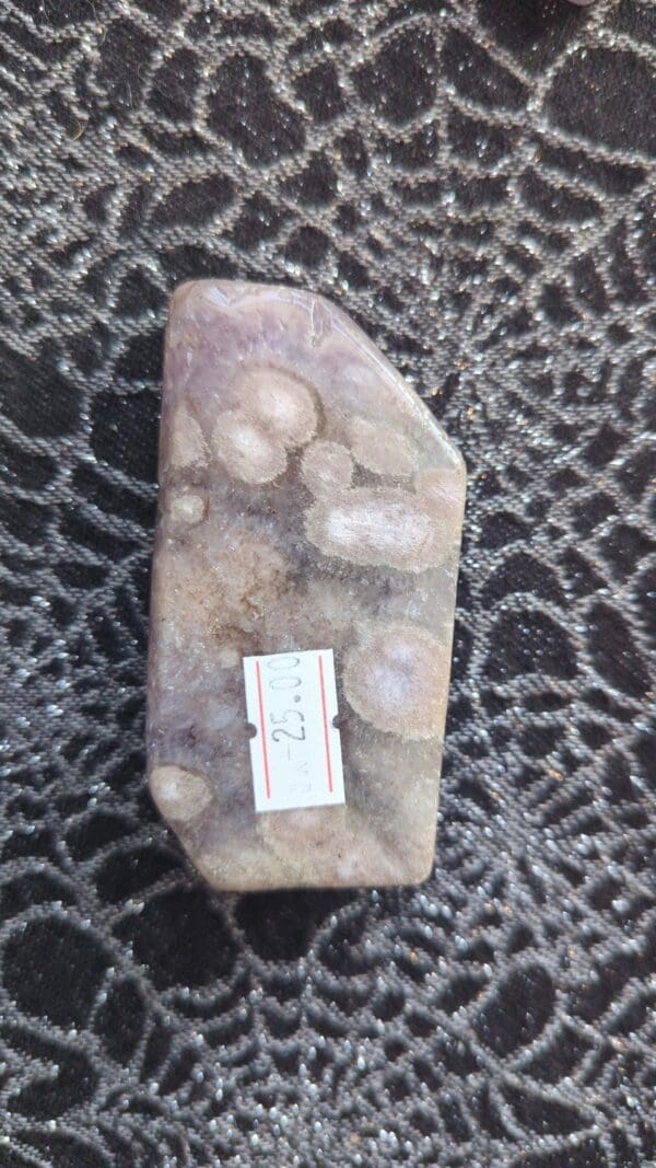 A piece of stone with some stickers on it