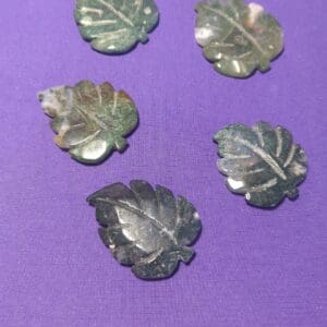 A close up of some leaves on a purple surface