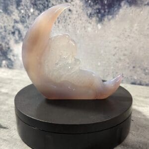 A small moon sculpture sitting on top of a table.