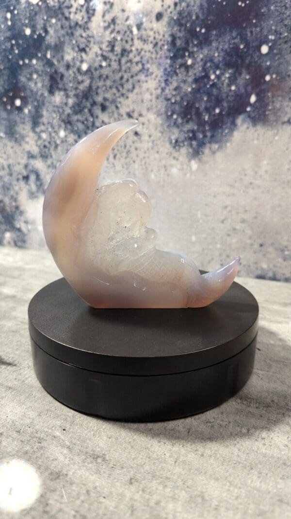 A small moon sculpture sitting on top of a table.