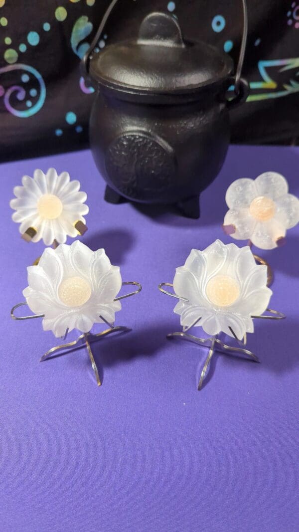 A purple table with four white flowers on it.