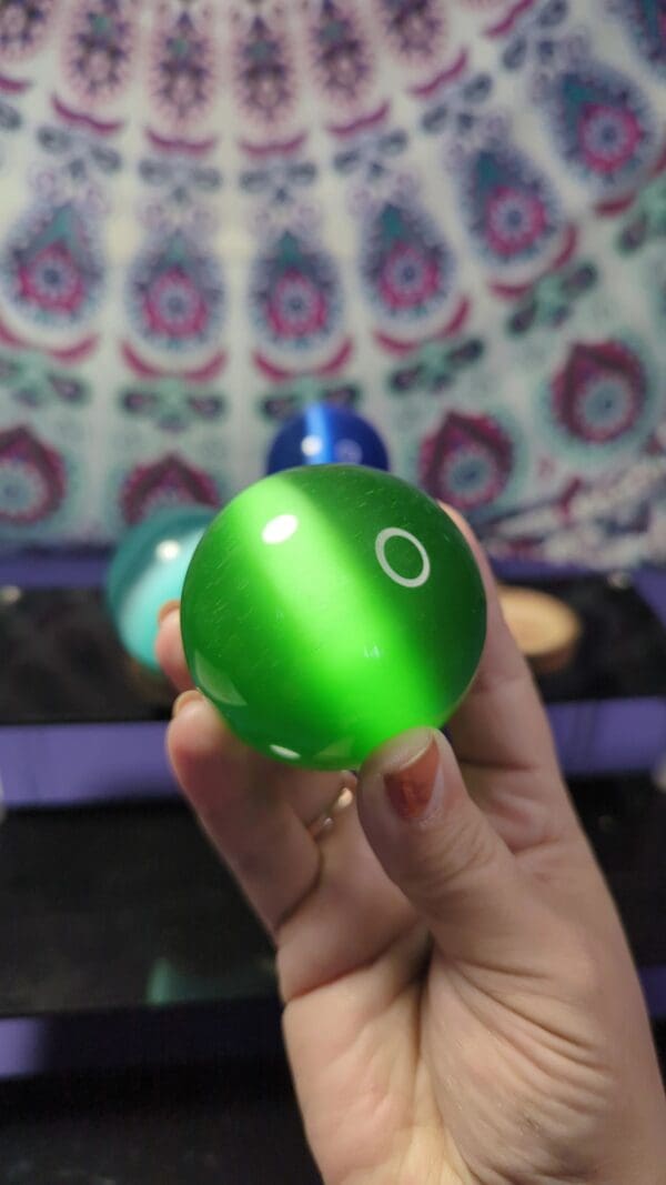 A person holding a green ball in their hand.