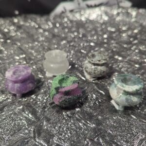 A group of four different colored rocks on top of a table.