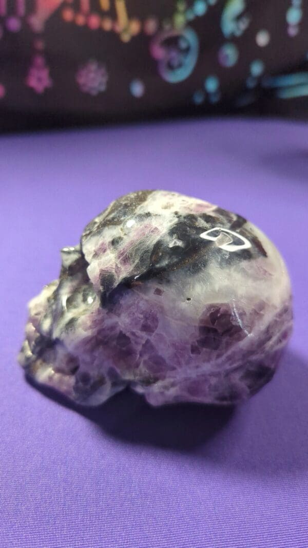 A skull with purple and white spots on it.