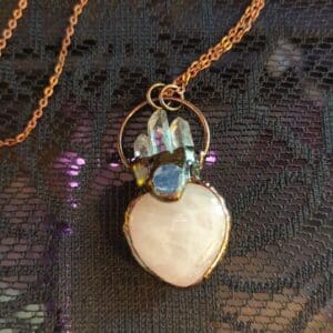 A necklace with a heart shaped stone on it.