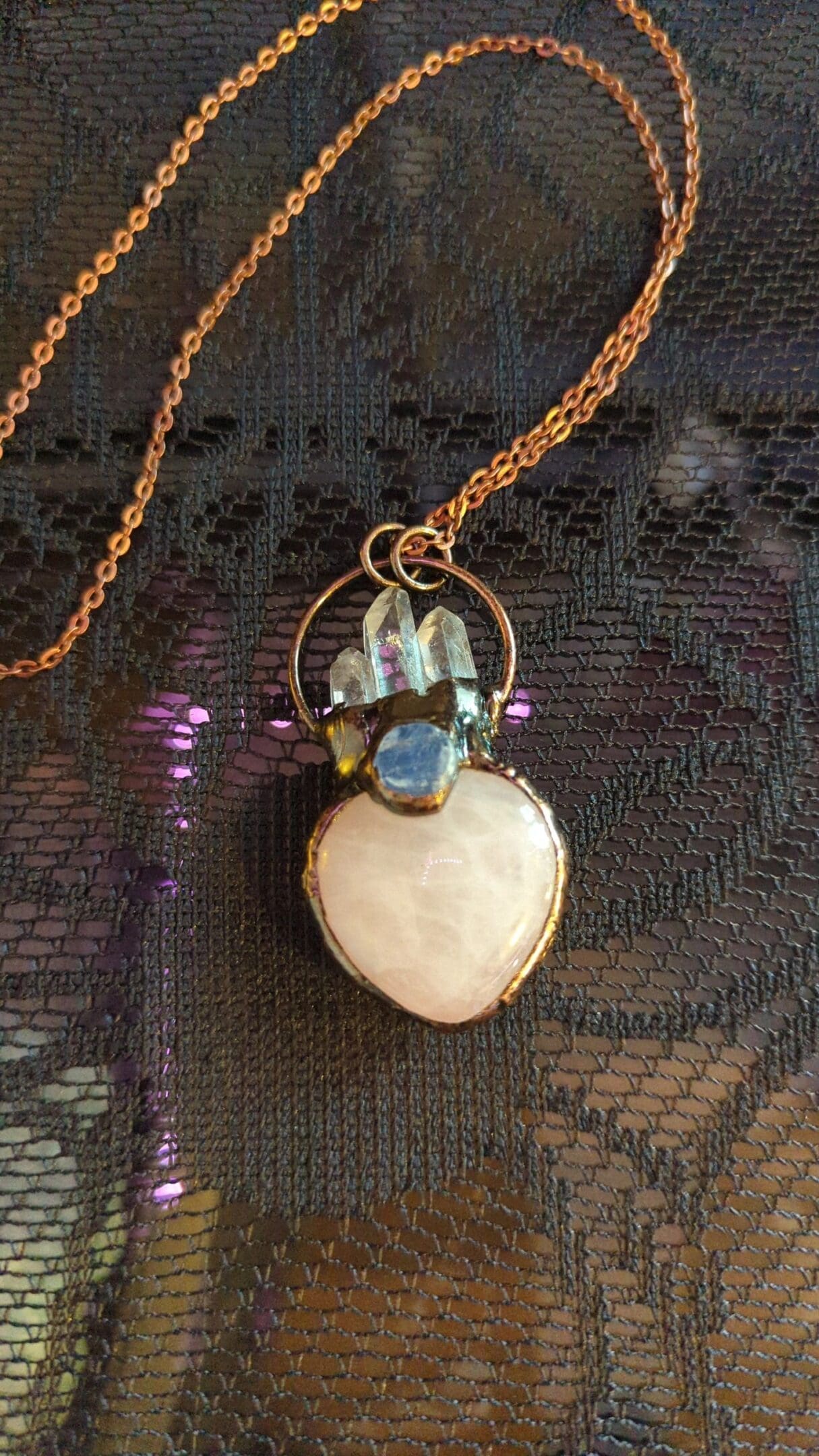 A necklace with a heart shaped stone on it.