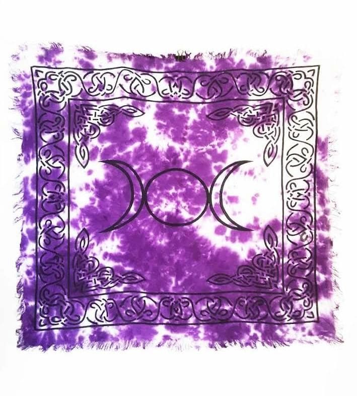 A purple tie dye altar cloth with the triple moon symbol.