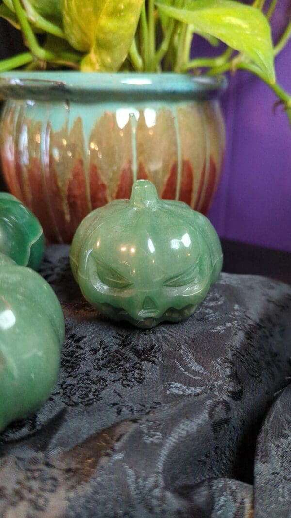 A green pumpkin sitting on top of a table.