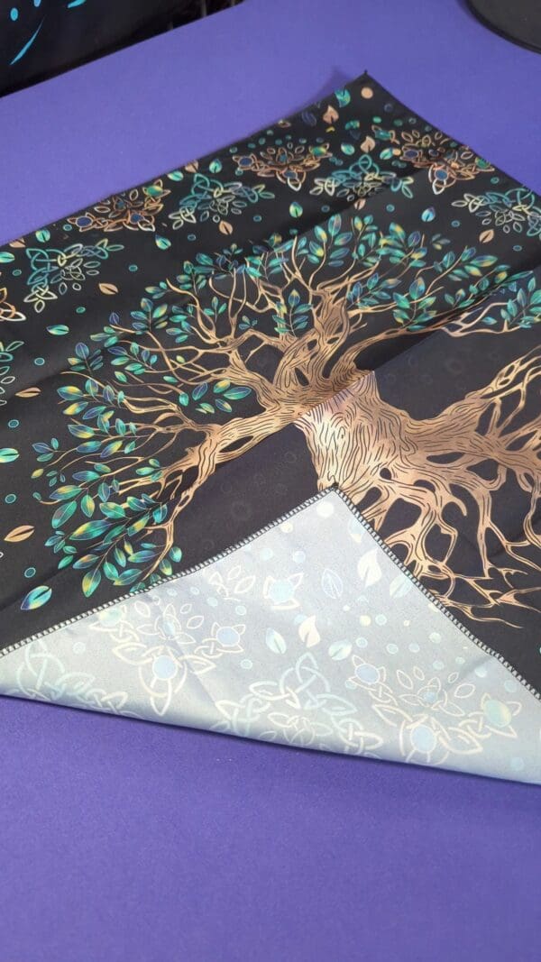 A close up of the tree of life on a quilt