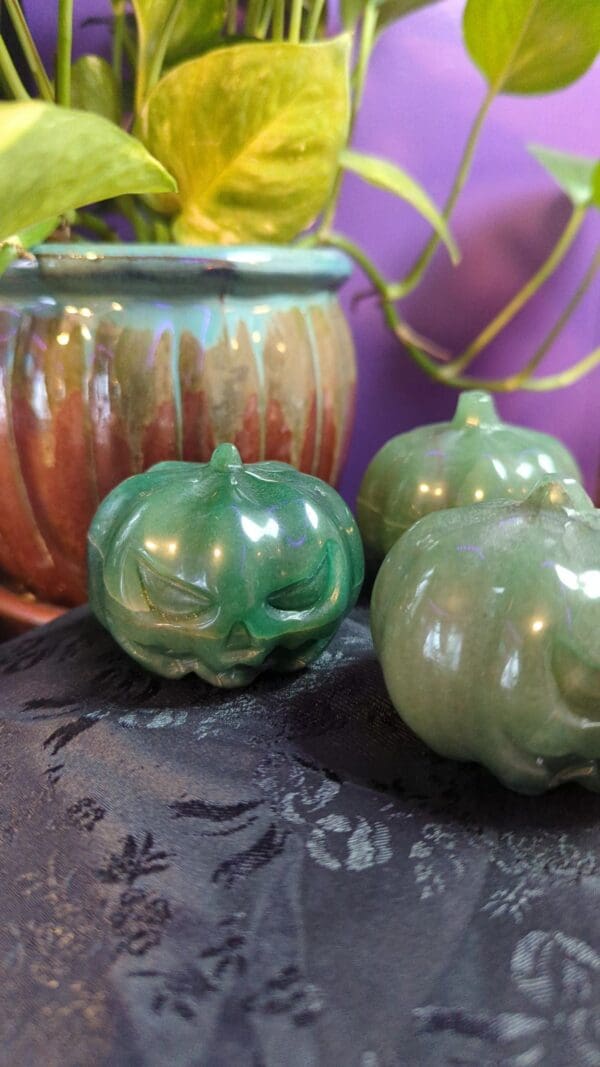 A close up of three green pumpkins on a table