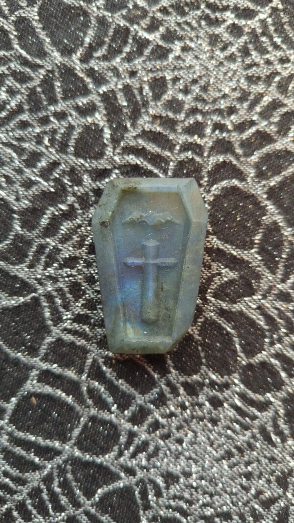 A small blue coffin with a cross on it.