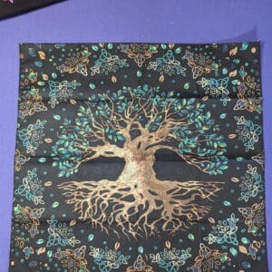 A picture of the tree of life on a pillow.