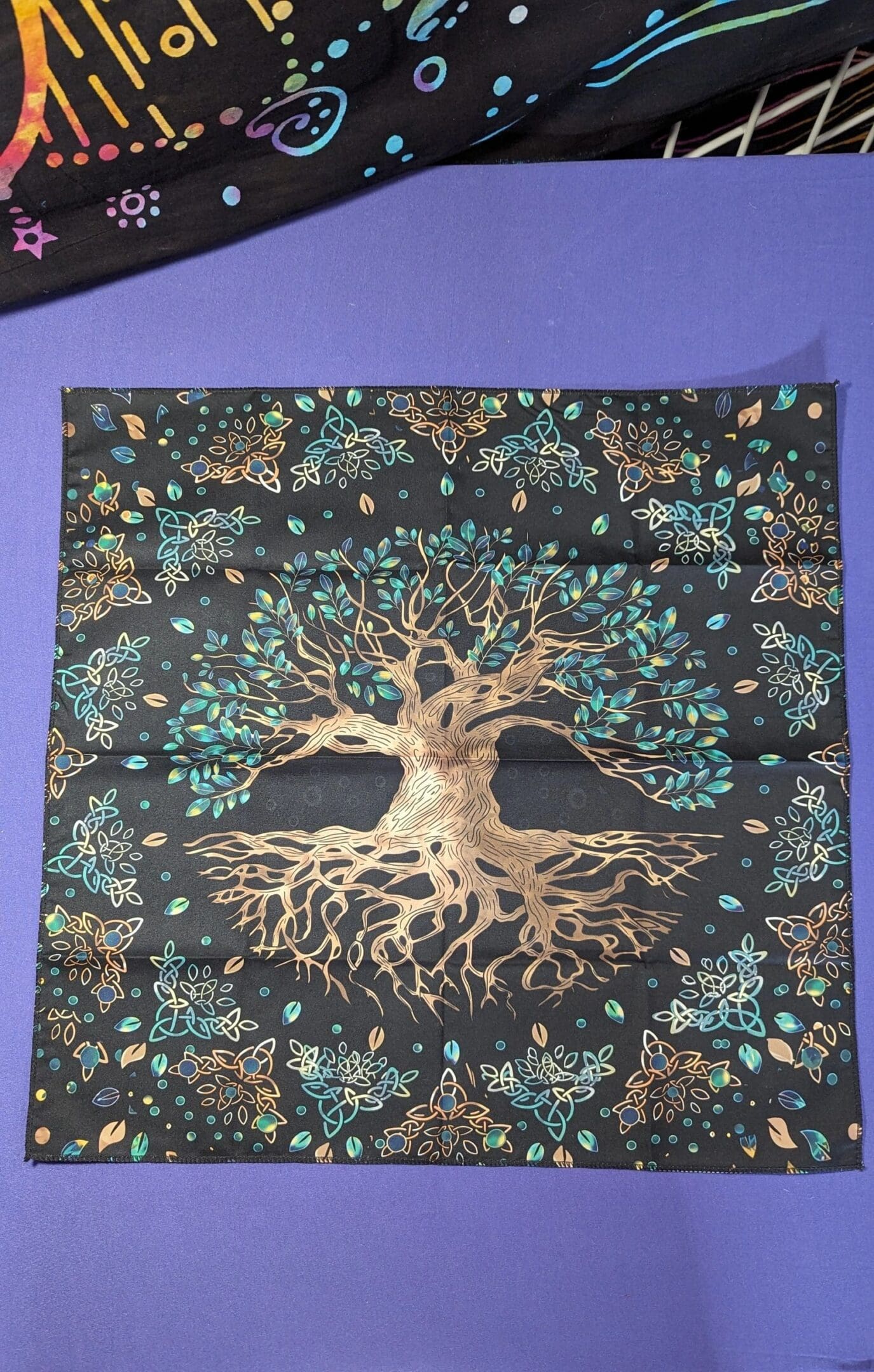 A picture of the tree of life on a pillow.